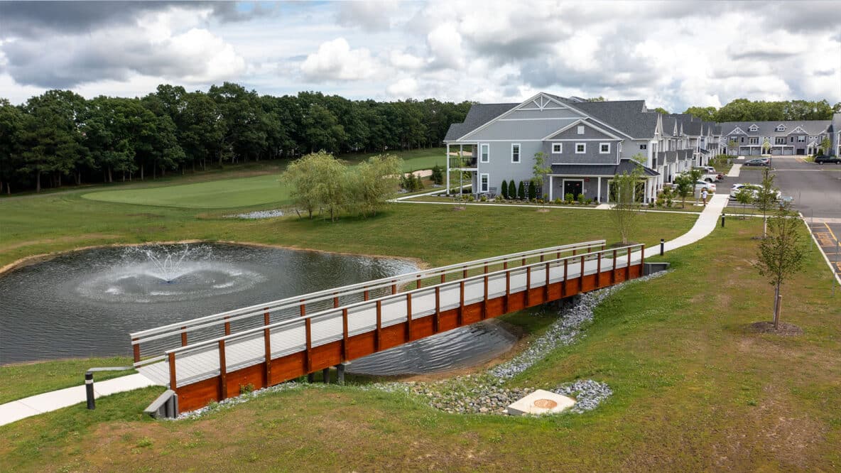 Side aerial profile image of the Heatherwood Spy Glass Golf & Villas Pedestrian Timber Bridge by York Bridge Concepts in Setauket, NY