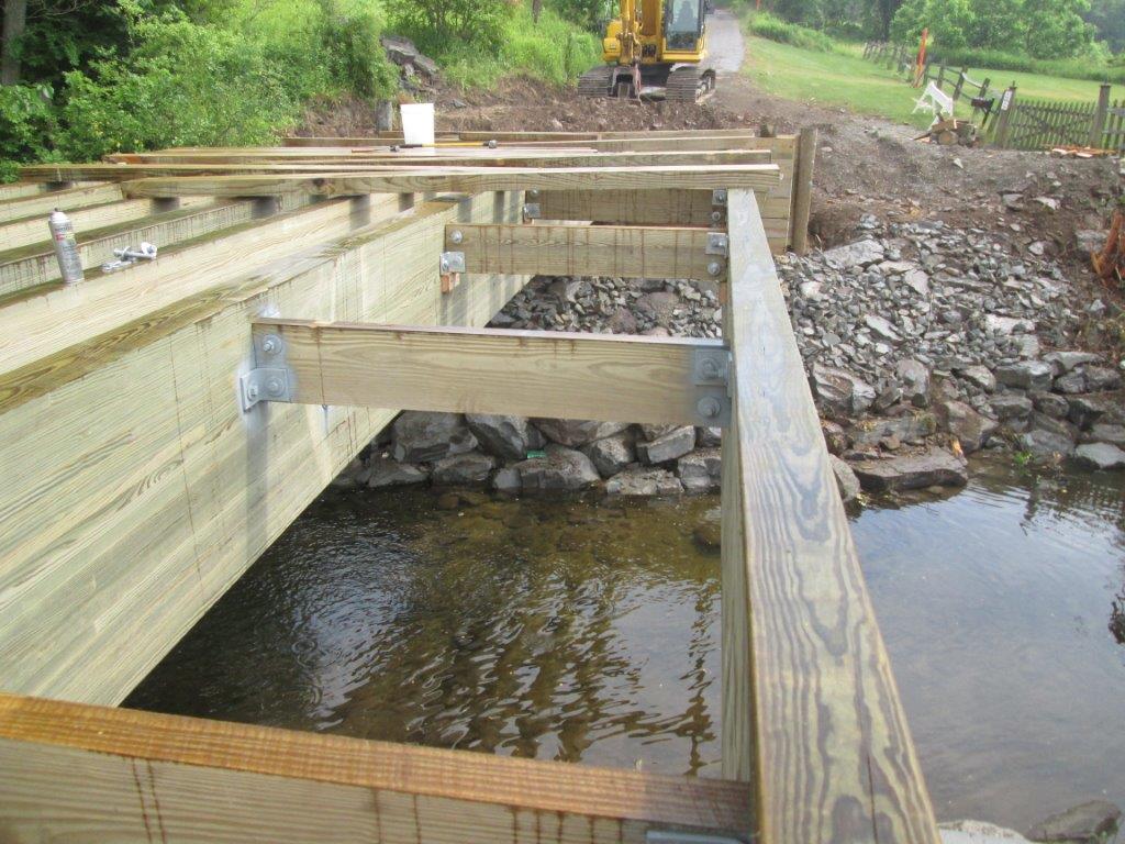 Timber selection & treatment for the Keystone College timber vehicular bridge in La Plume, PA by York Bridge Concepts