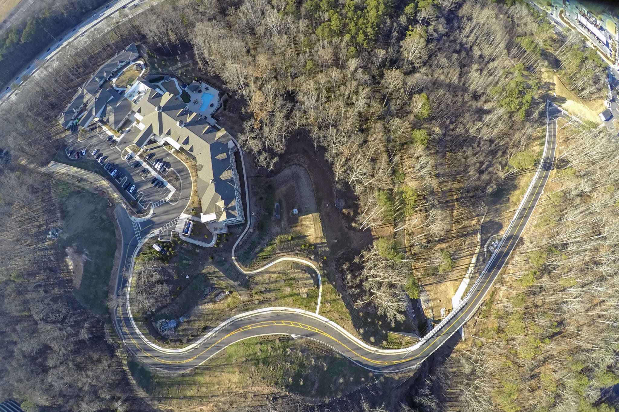 Aerial of community and the timber vehicular bridge of Inspired Living