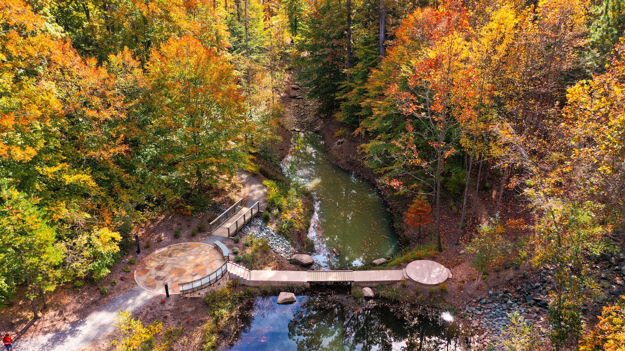 University of Virginia aerial shot of footbridge over pond